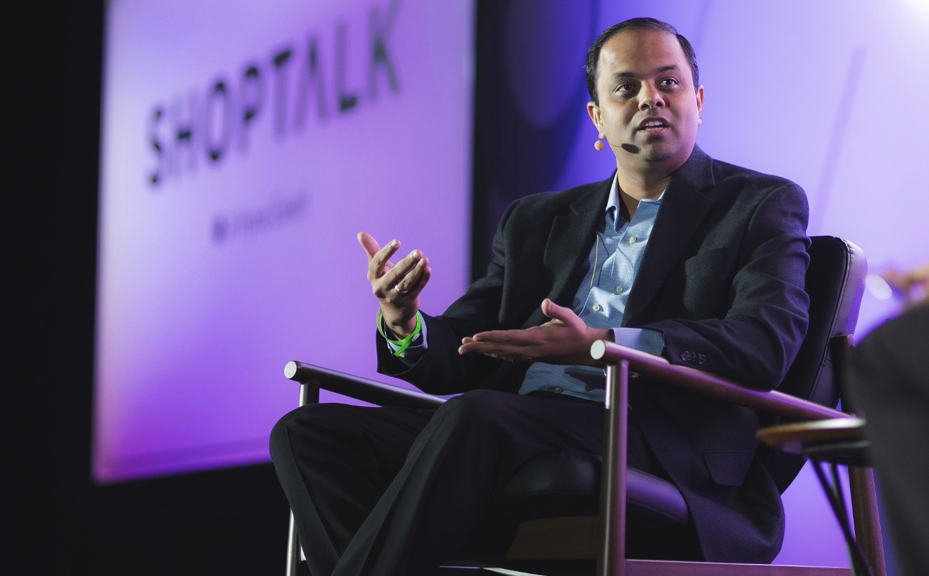 A person in a suit speaking AI-generated content may be incorrect.